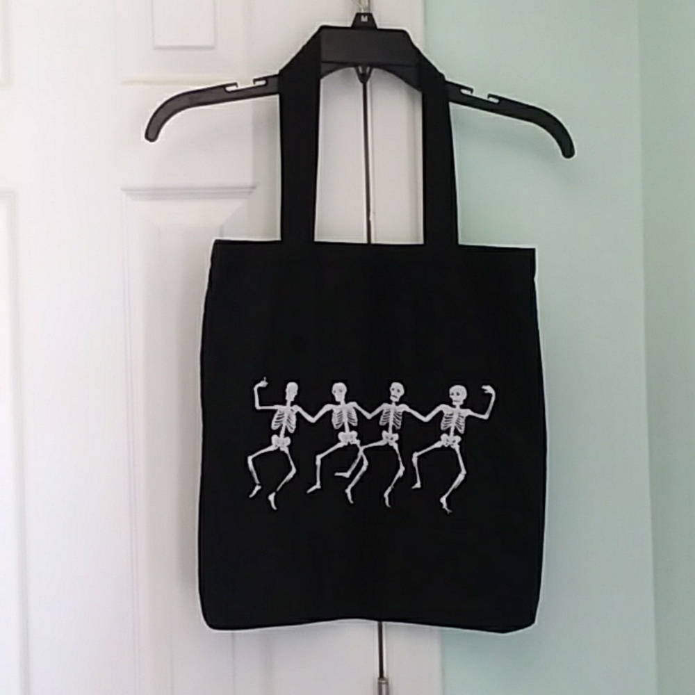 Black canvas tote with dancing skeletons